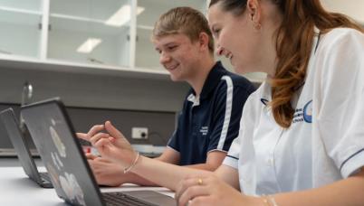 Students looking at laptop