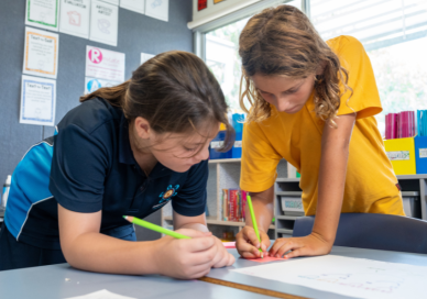 Students writing on a post-it note